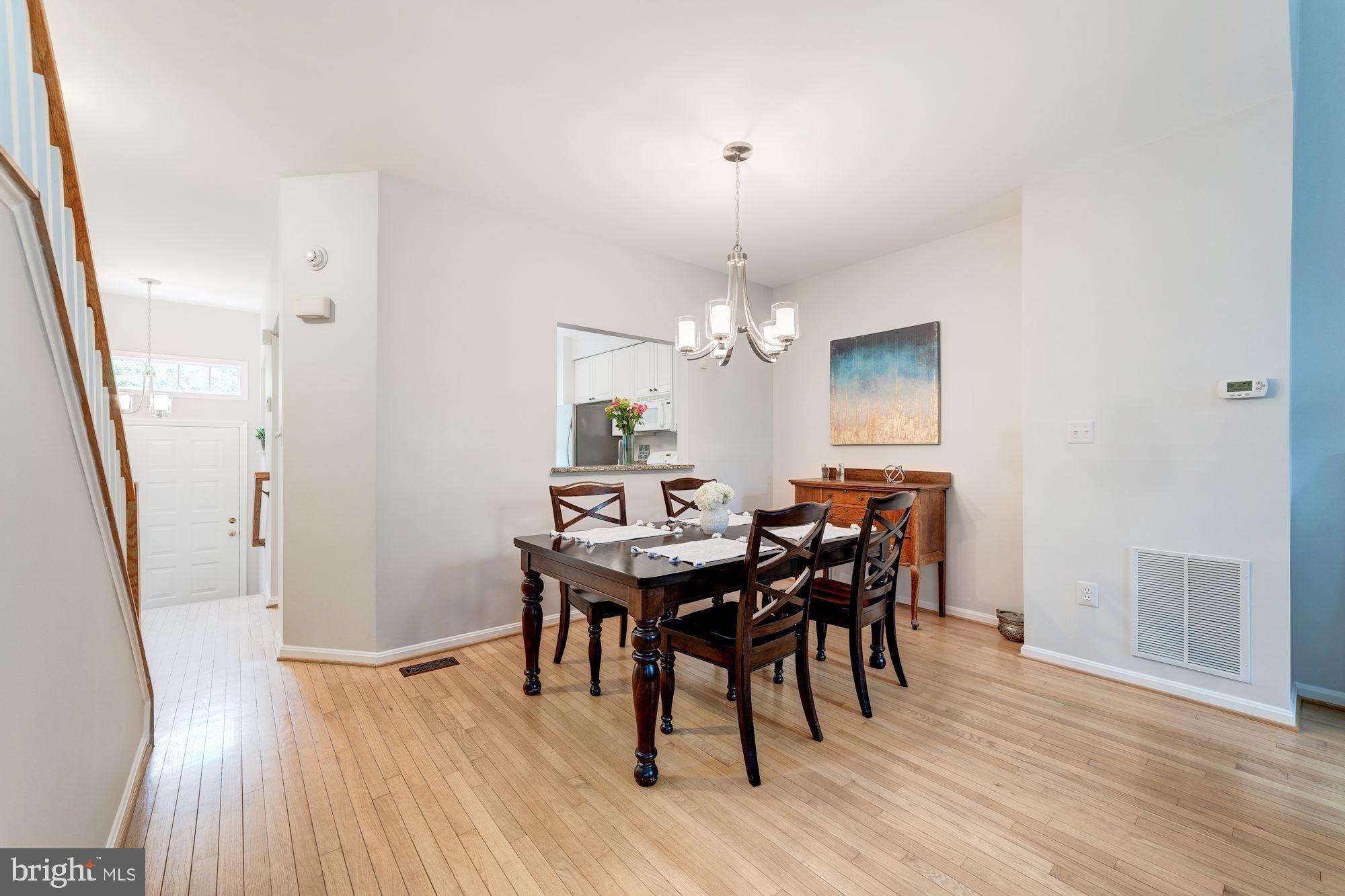 1283 Weatherstone Court Reston, VA 20194 - Photo 9 of 38 a view of a dining room with furniture and wooden floor