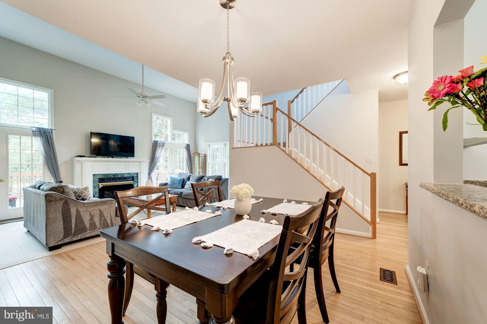 1283 Weatherstone Court Reston, VA 20194 - Photo 10 of 38 a view of a dining room with furniture and wooden floor