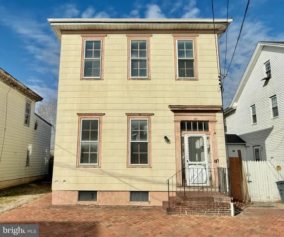 a view of a white house with many windows