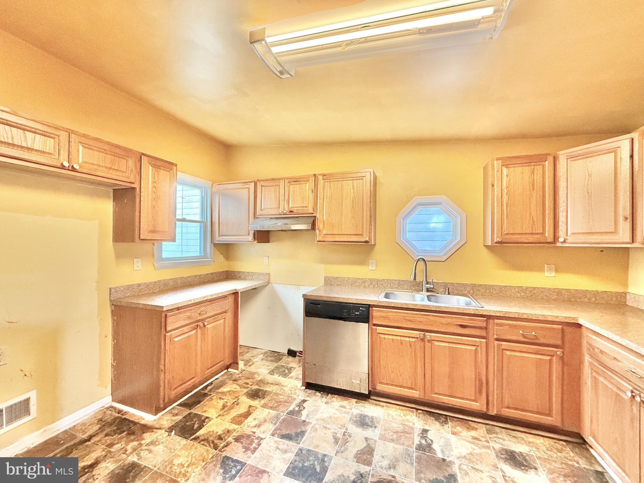 187 7th Street Salem, NJ 08079 - Photo 14 of 26 a kitchen with stainless steel appliances granite countertop a sink a stove cabinets counter space and living room