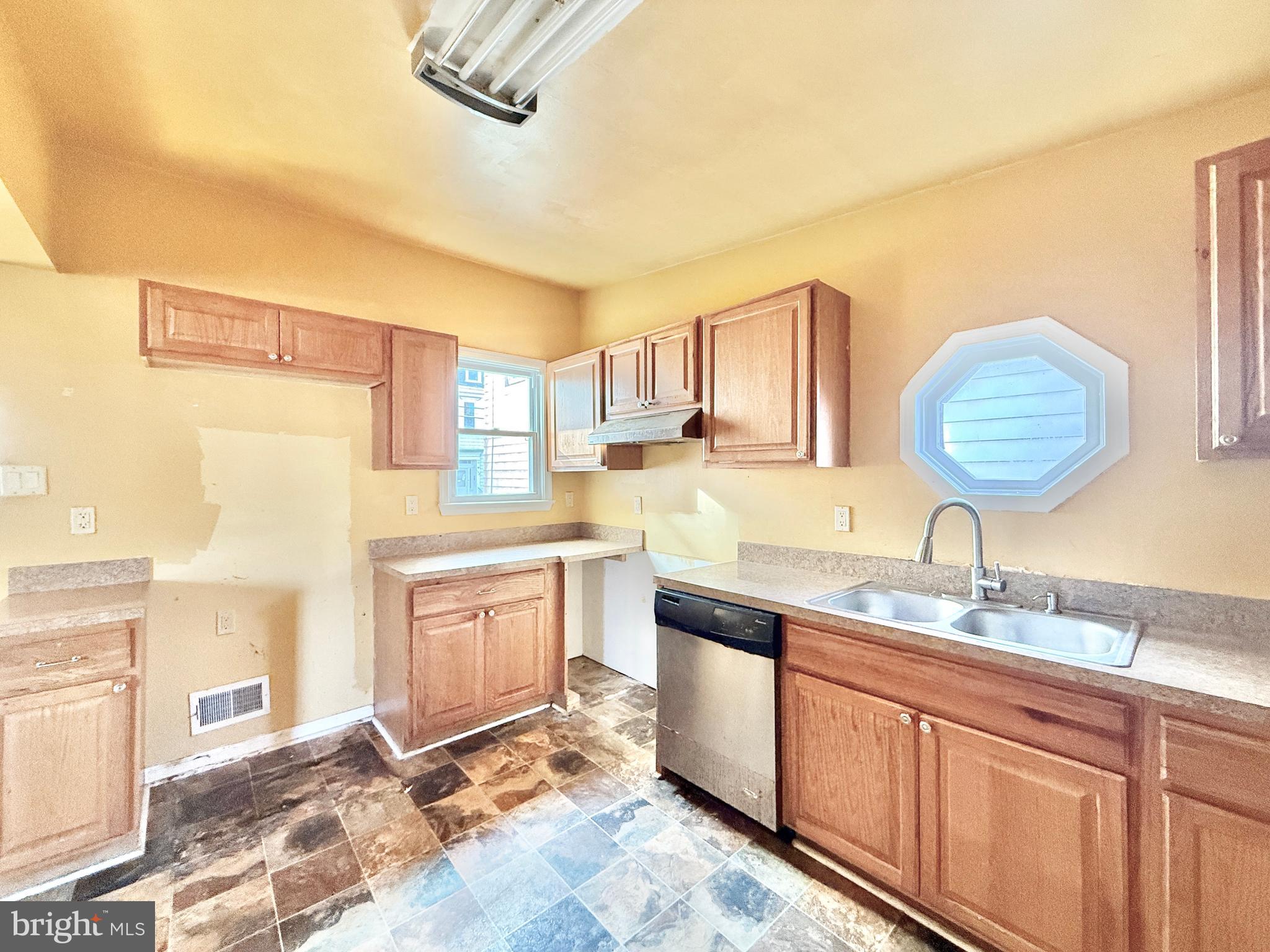 187 7th Street Salem, NJ 08079 - Photo 15 of 26 a kitchen with granite countertop a sink cabinets and stainless steel appliances