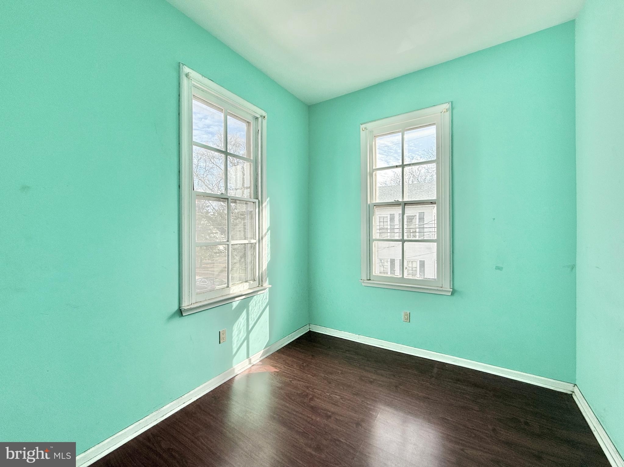 187 7th Street Salem, NJ 08079 - Photo 19 of 26 a view of an empty room with wooden floor and a window