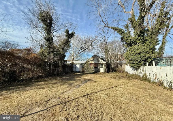 a view of the house with a yard covered with snow