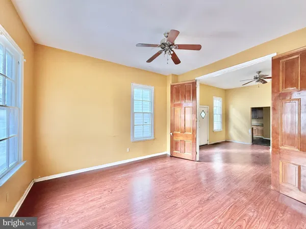 wooden floor in an empty room with a window