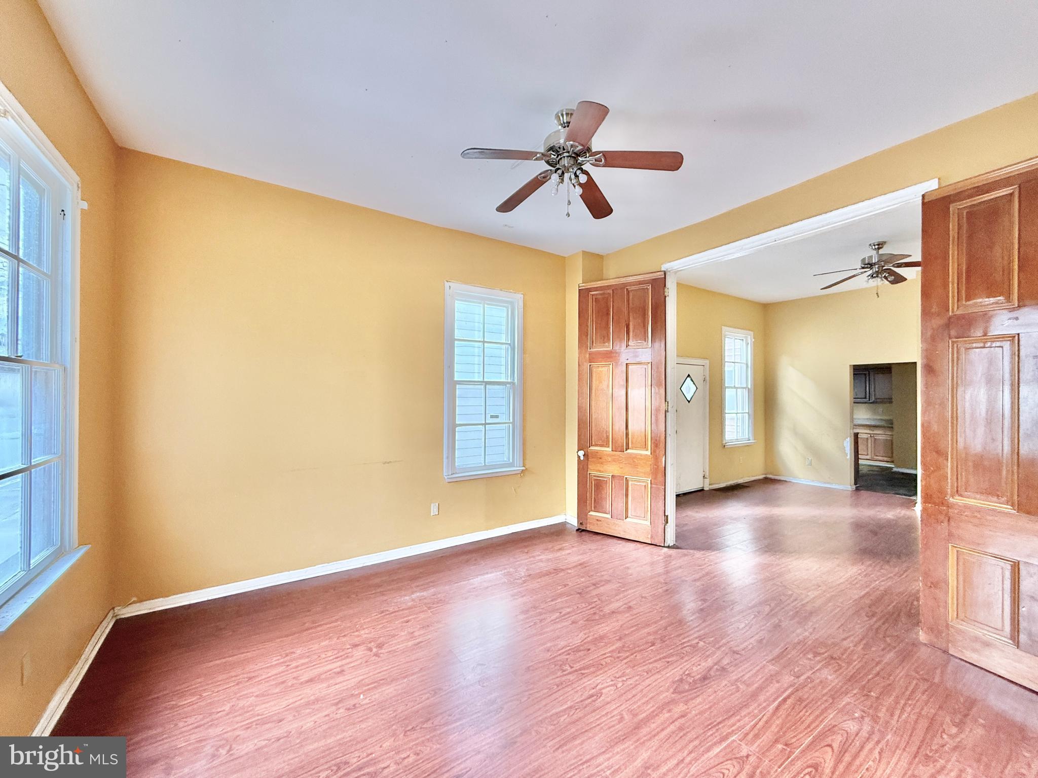 187 7th Street Salem, NJ 08079 - Photo 9 of 26 a view of an empty room with window and wooden floor