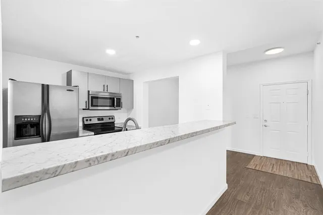a kitchen with stainless steel appliances granite countertop a sink and a stove