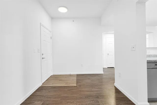 a kitchen with granite countertop a stove a microwave a refrigerator and stainless steel appliances