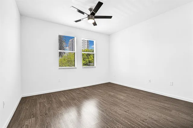 a view of a room with wooden floor and windows