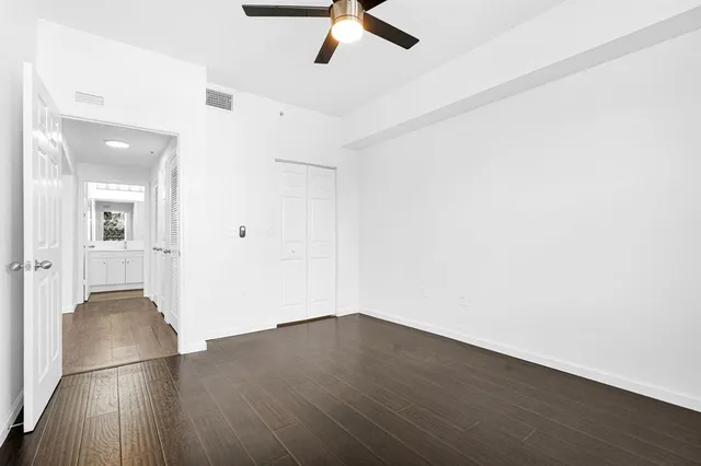 a view of a room with wooden floor and windows