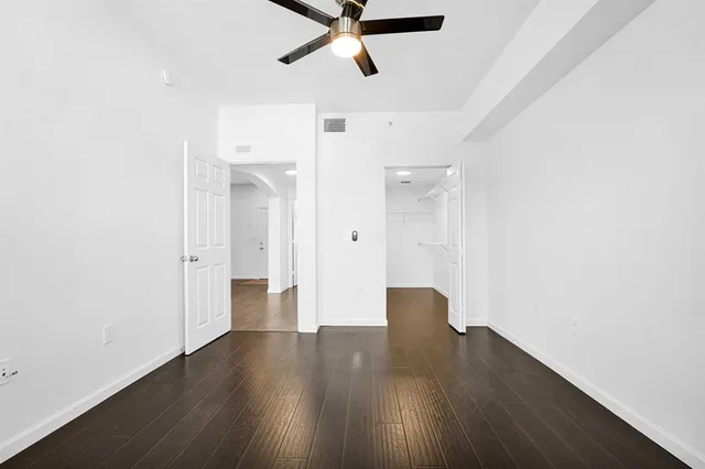 a big room with wooden floor and windows