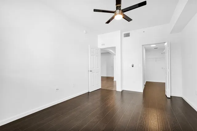 a living room with furniture a flat screen tv and a large window