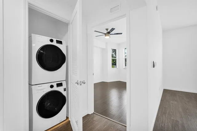 a view of a tables and chairs under an umbrella in backyard