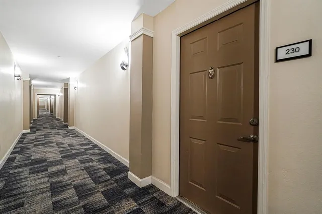 a view of kitchen with stainless steel appliances a refrigerator and a window