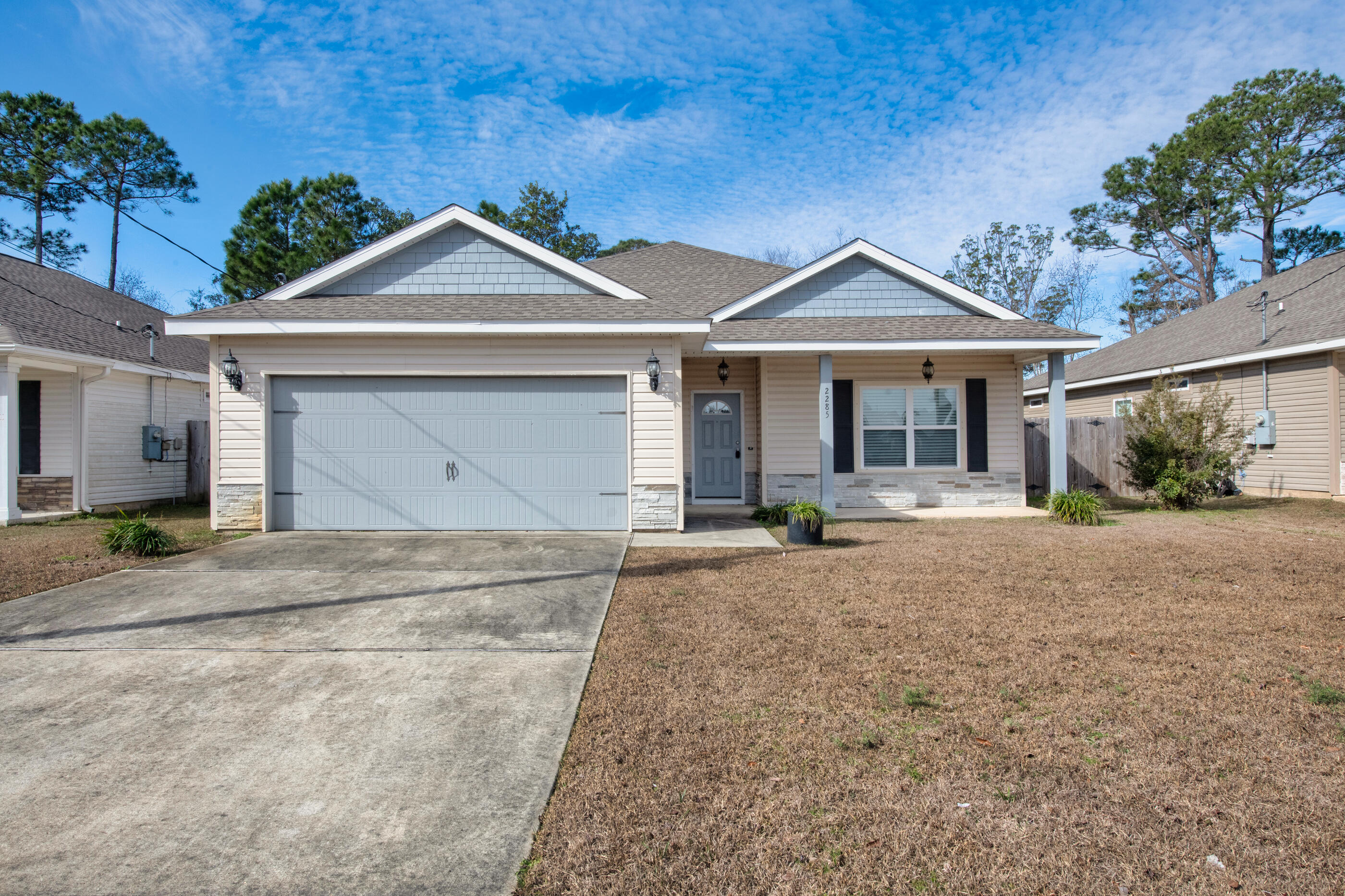 a front view of a house with a yard and garage