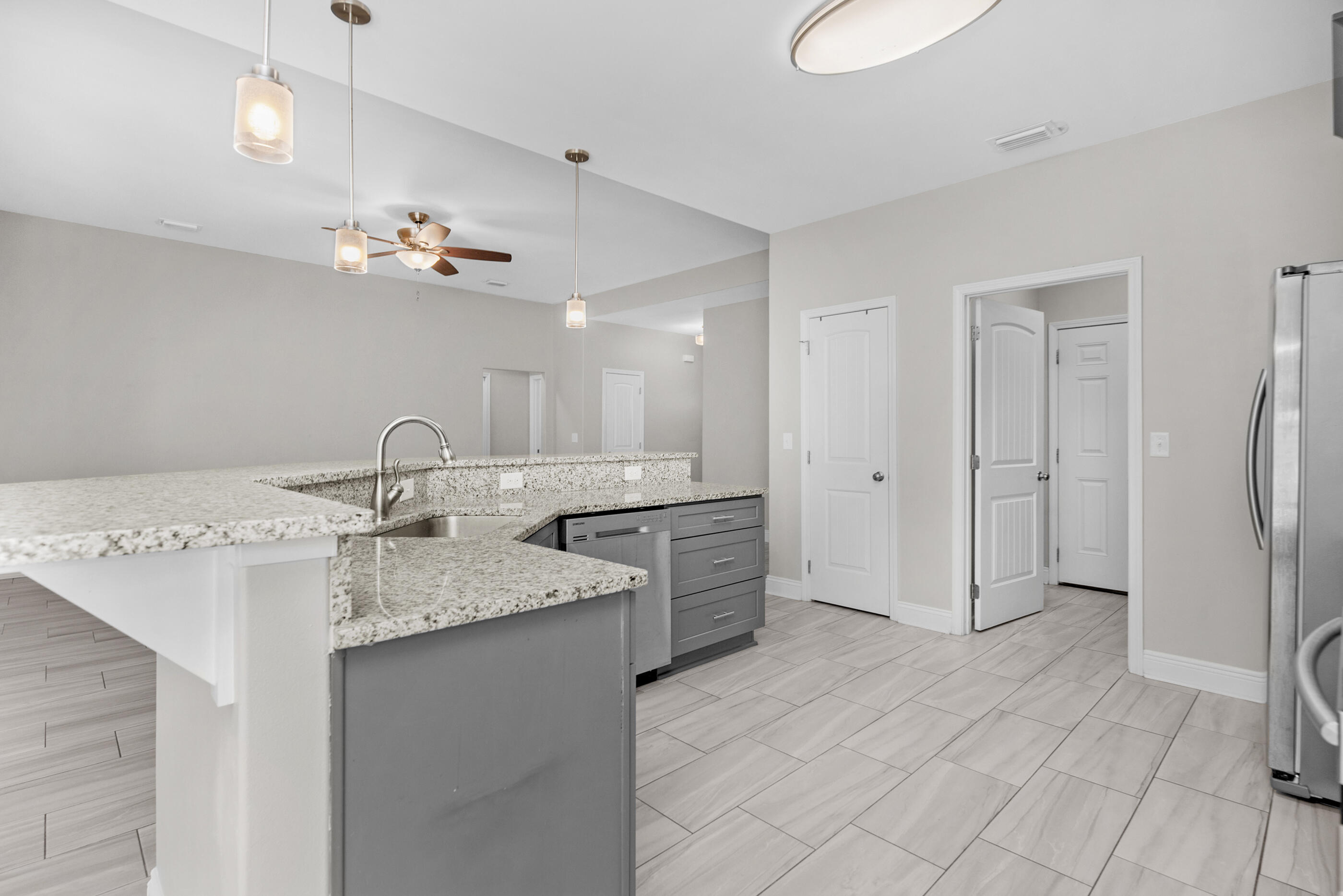 2285 Tom Street Navarre, FL 32566 - Photo 12 of 36 a bathroom with a granite countertop sink two mirror and shower