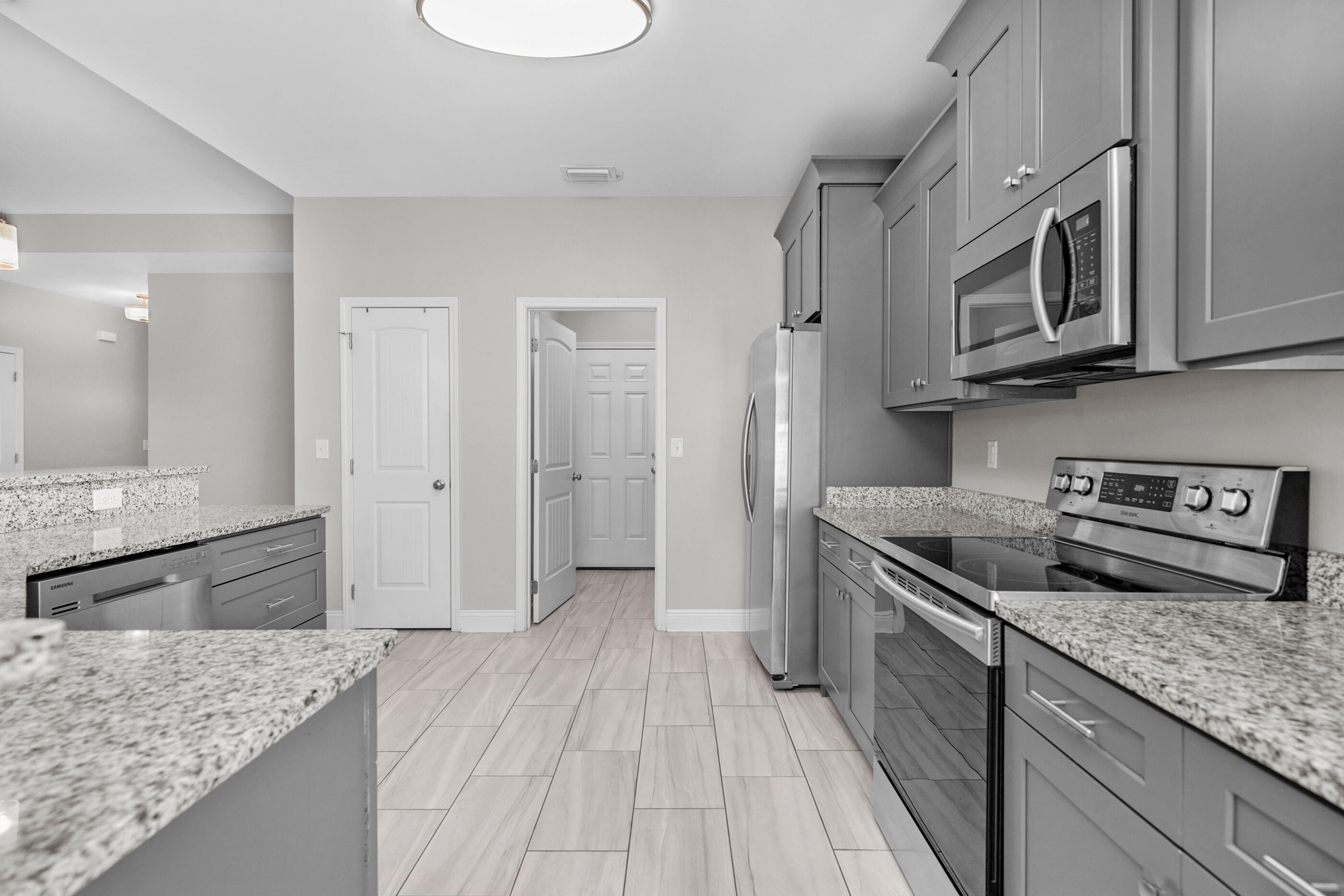 2285 Tom Street Navarre, FL 32566 - Photo 13 of 36 a kitchen with stainless steel appliances granite countertop a sink stove and refrigerator