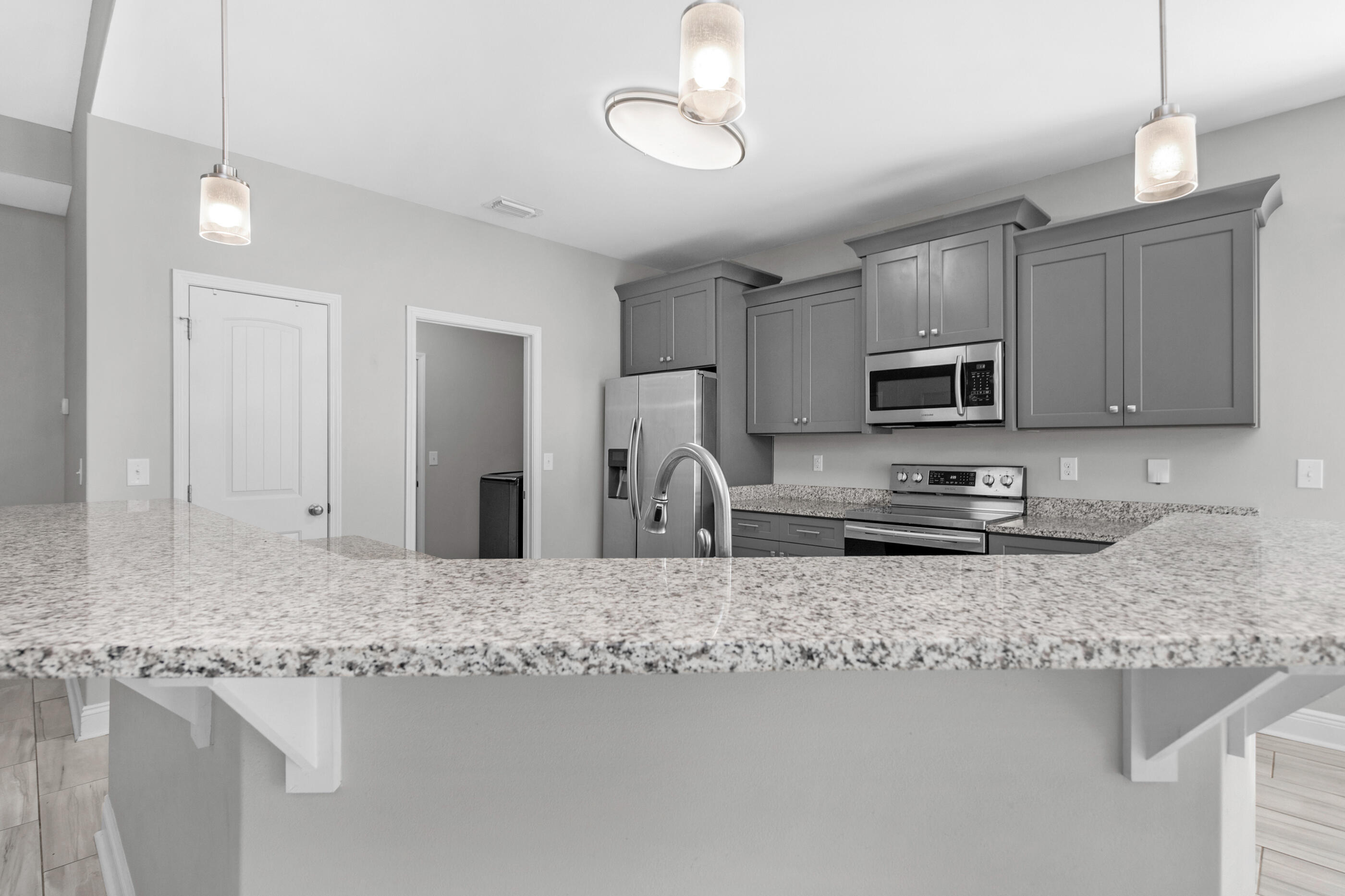 2285 Tom Street Navarre, FL 32566 - Photo 14 of 36 a kitchen with appliances a sink and cabinets