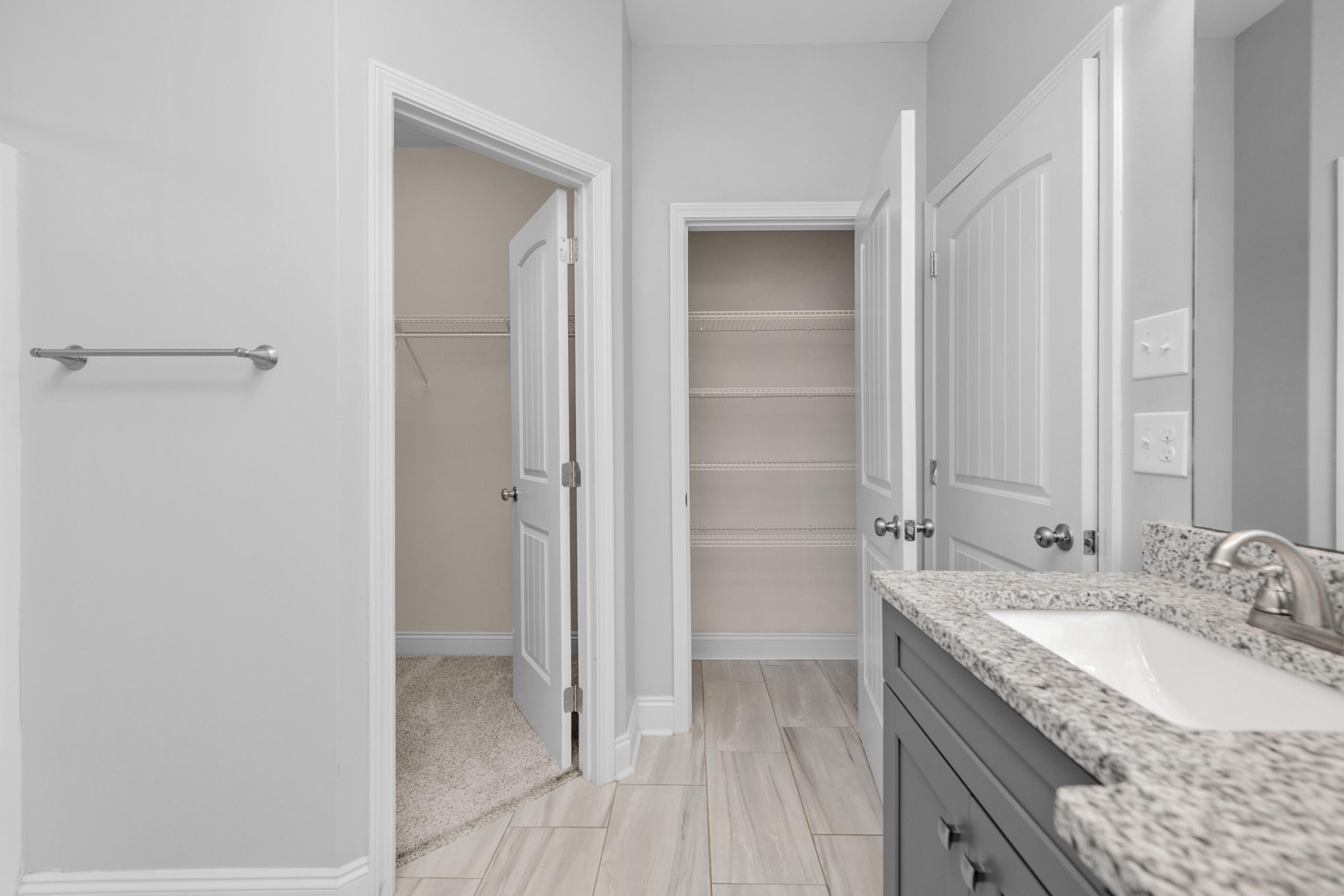 2285 Tom Street Navarre, FL 32566 - Photo 19 of 36 a bathroom with a granite countertop sink a mirror and a shower