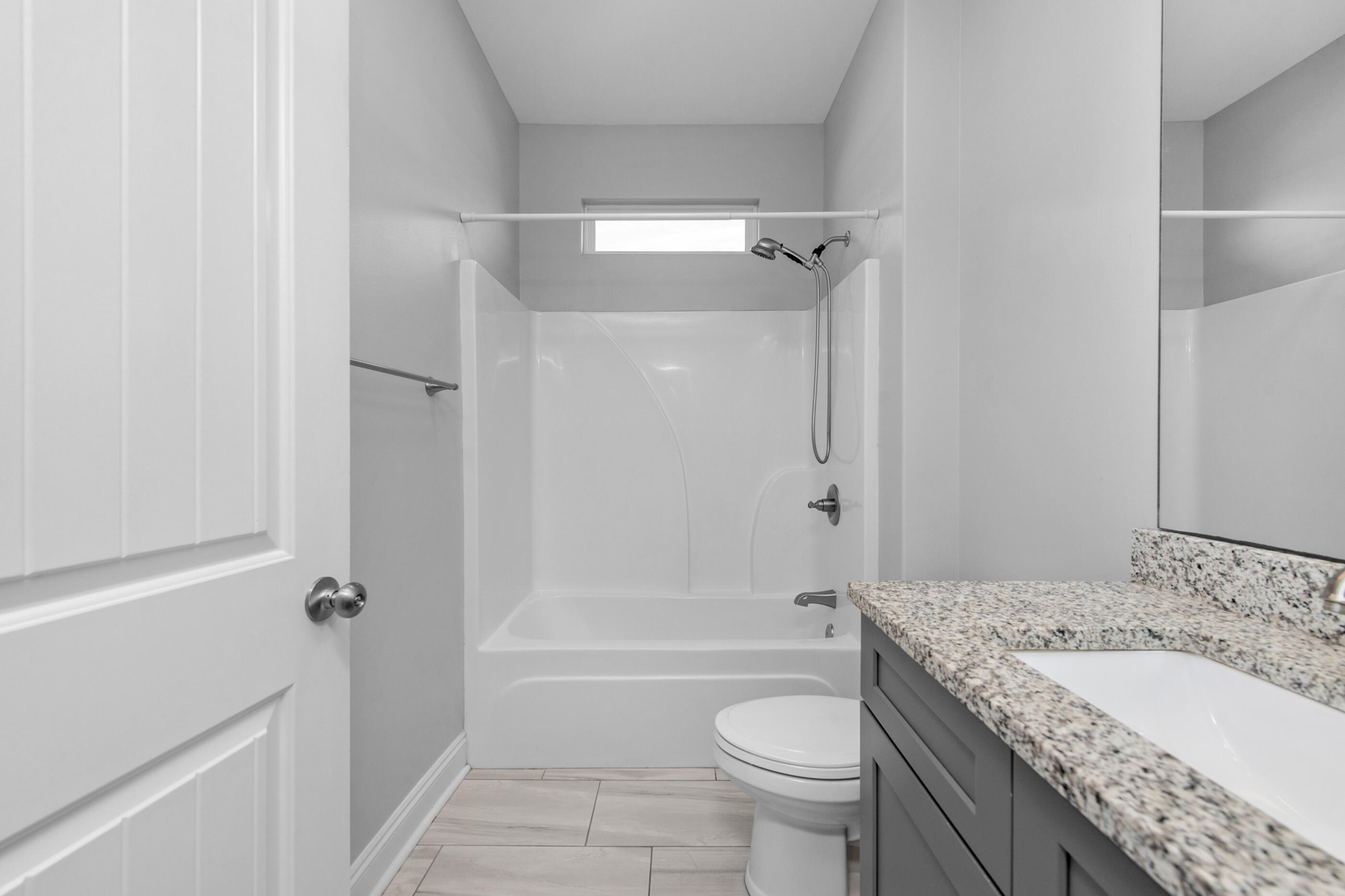 2285 Tom Street Navarre, FL 32566 - Photo 30 of 36 a bathroom with a granite countertop toilet a sink and a bathtub