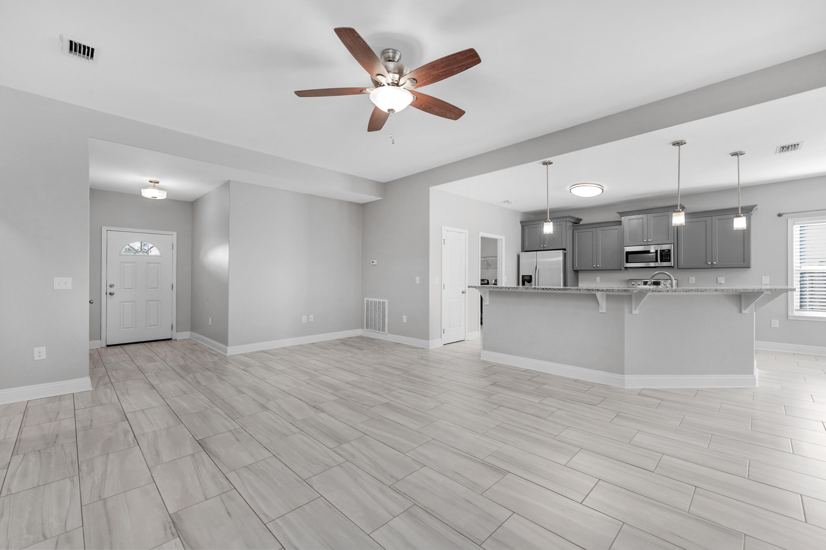 2285 Tom Street Navarre, FL 32566 - Photo 3 of 36 a view of an empty room and kitchen view