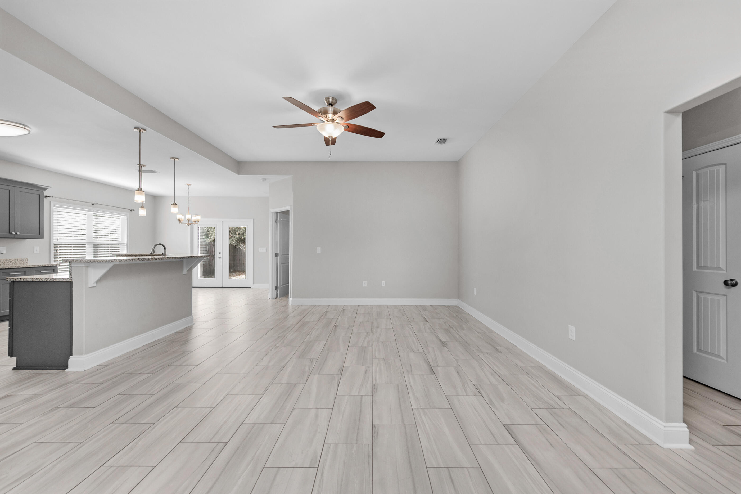 2285 Tom Street Navarre, FL 32566 - Photo 4 of 36 a view of a kitchen with wooden floor and a kitchen