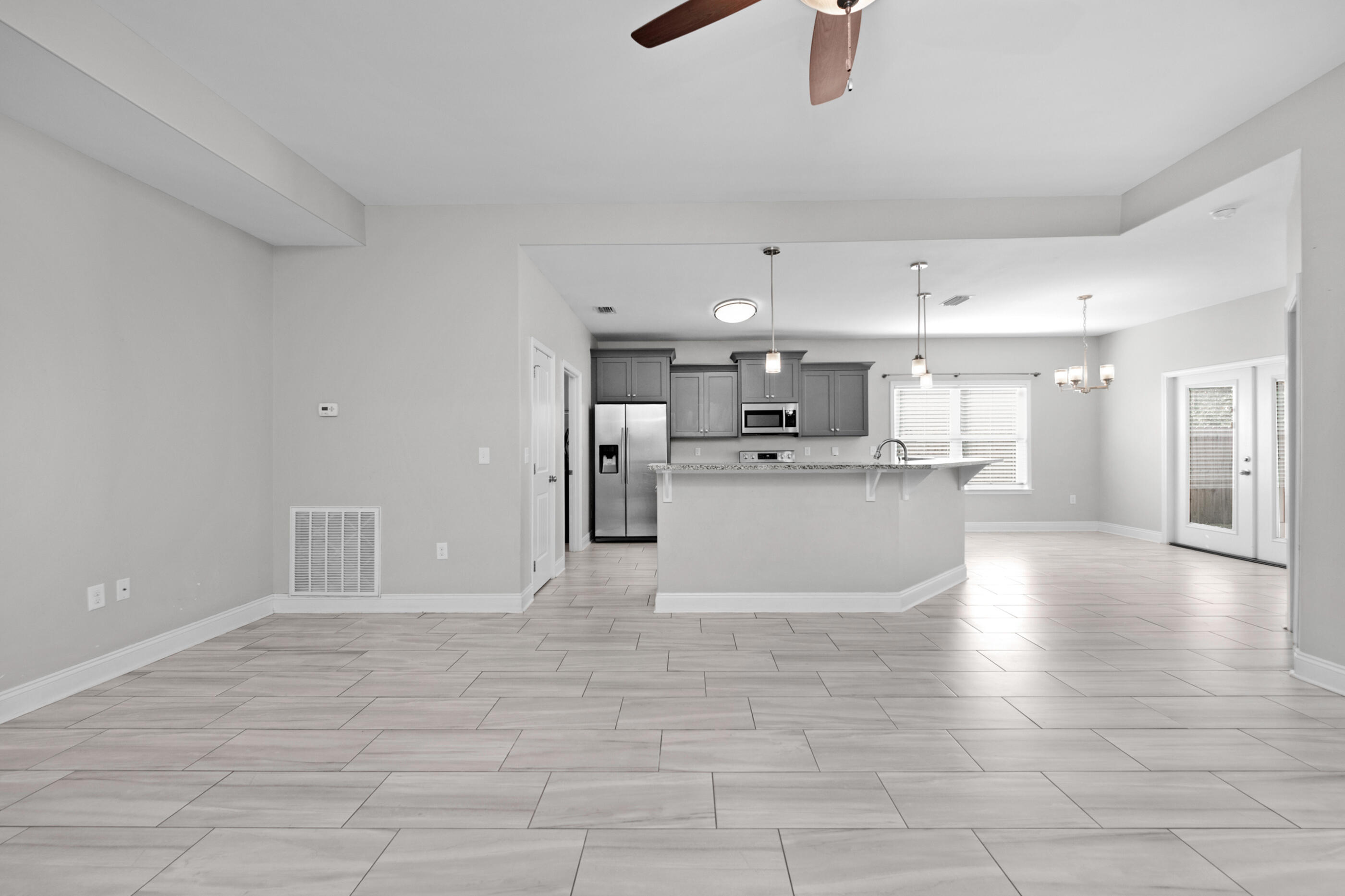 2285 Tom Street Navarre, FL 32566 - Photo 5 of 36 a view of a kitchen with furniture and wooden floor