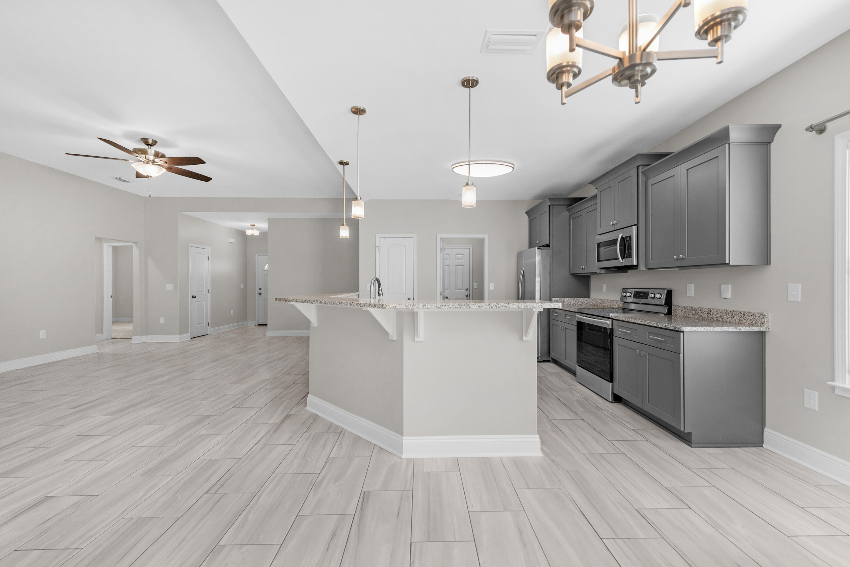 2285 Tom Street Navarre, FL 32566 - Photo 6 of 36 a view of kitchen with sink microwave and stove top oven