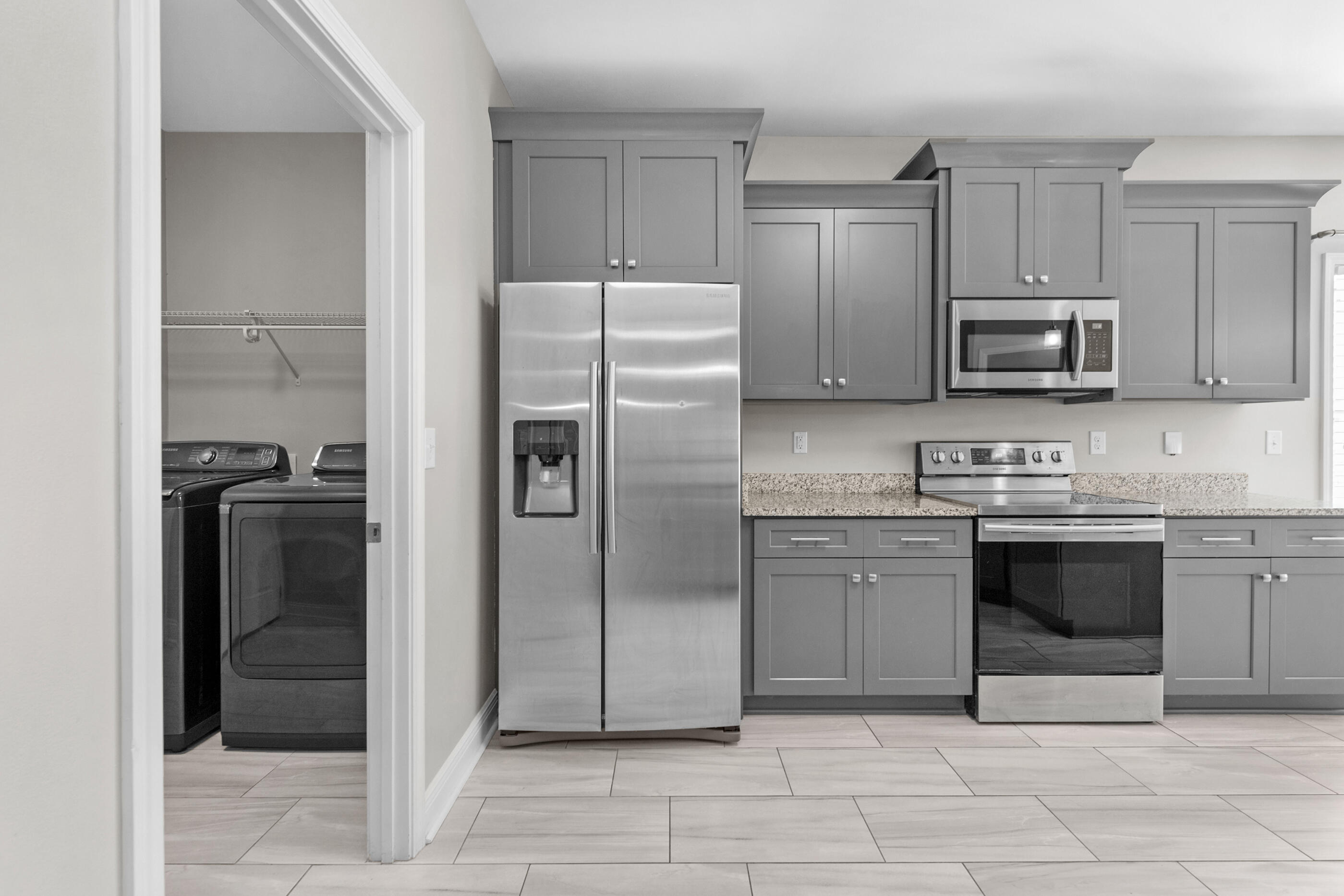 2285 Tom Street Navarre, FL 32566 - Photo 7 of 36 a kitchen with granite countertop a refrigerator and a stove top oven