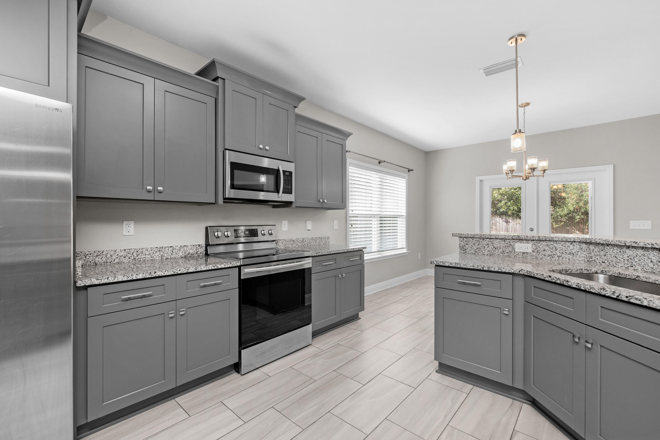 2285 Tom Street Navarre, FL 32566 - Photo 9 of 36 a kitchen with stainless steel appliances granite countertop a stove and a sink