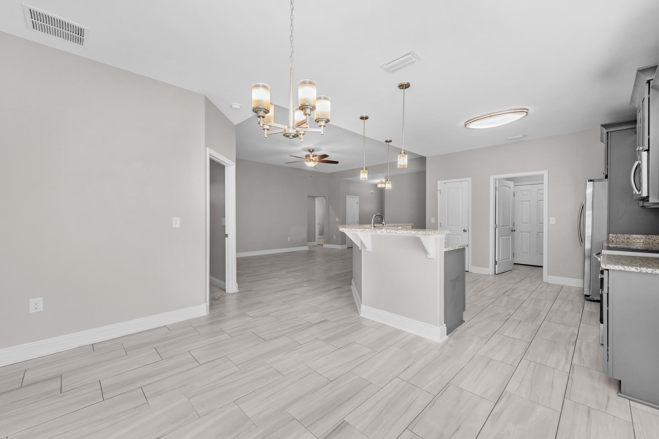 2285 Tom Street Navarre, FL 32566 - Photo 10 of 36 a view of a kitchen with a sink and refrigerator