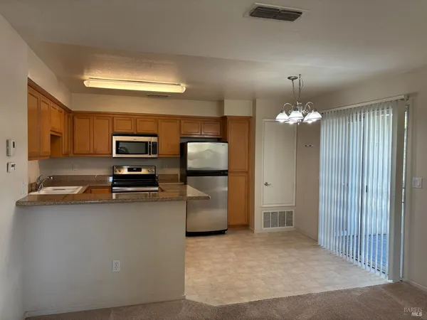 a kitchen with stainless steel appliances a refrigerator sink and stove top oven