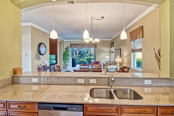 a kitchen with granite countertop a sink and a large window