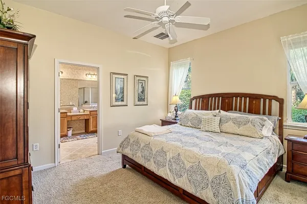 a bedroom with a bed and ceiling fan