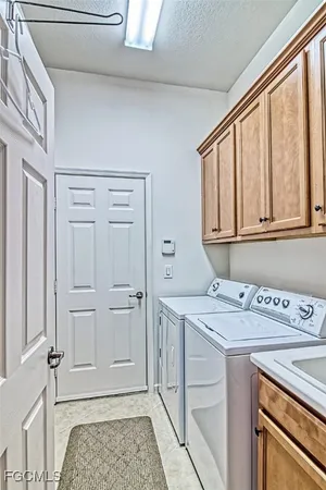 a utility room with a sink washer and dryer