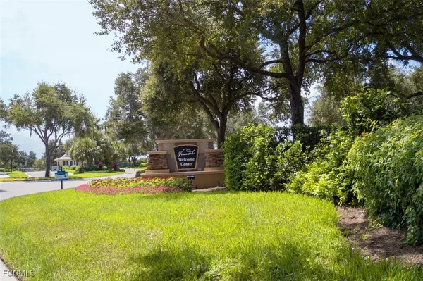 a view of a swimming pool with plants and trees