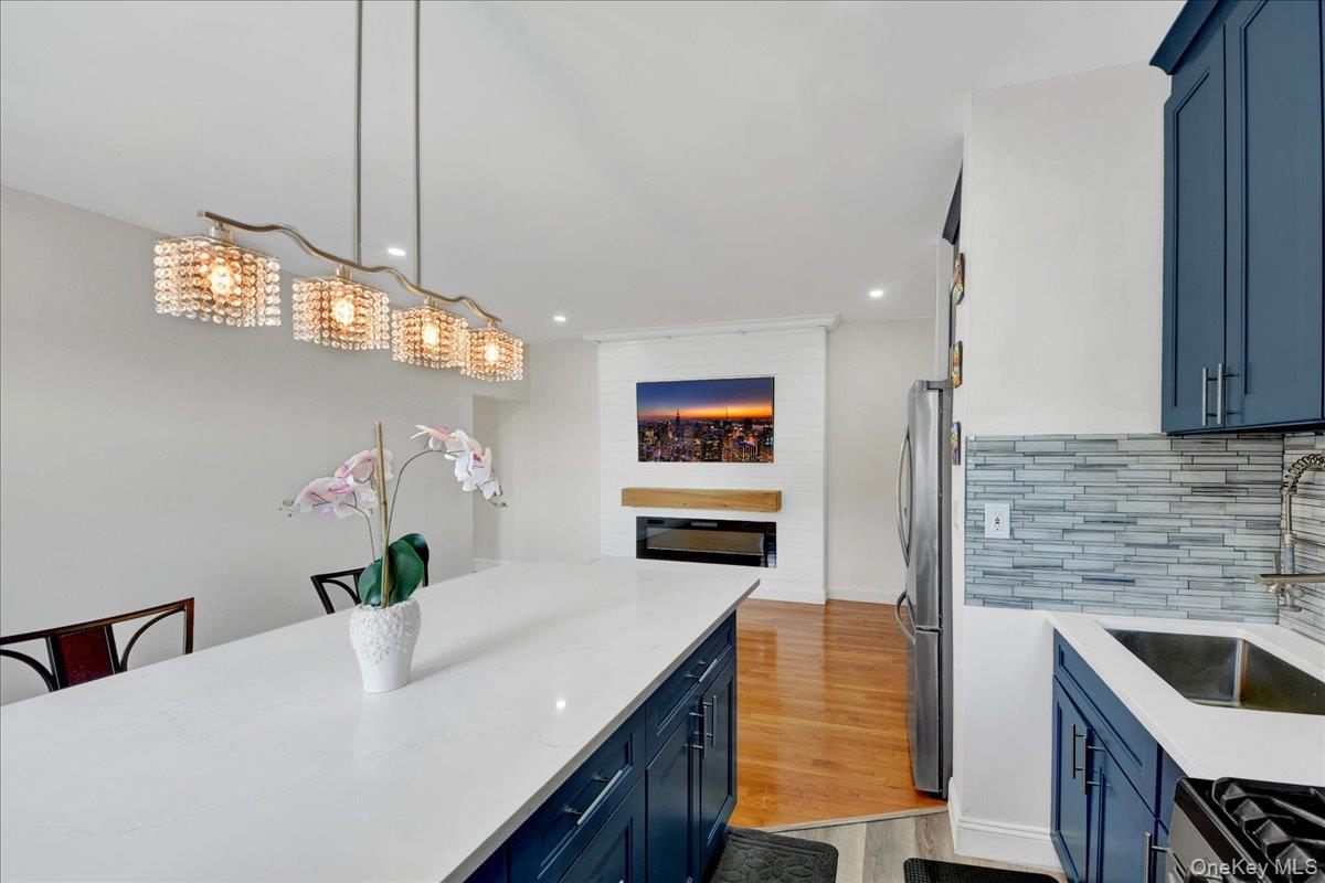 4784 Boston Post Road, Unit B43 Pelham, NY 10803 - Photo 4 of 22 a kitchen with stainless steel appliances kitchen island granite countertop a sink a counter space and cabinets