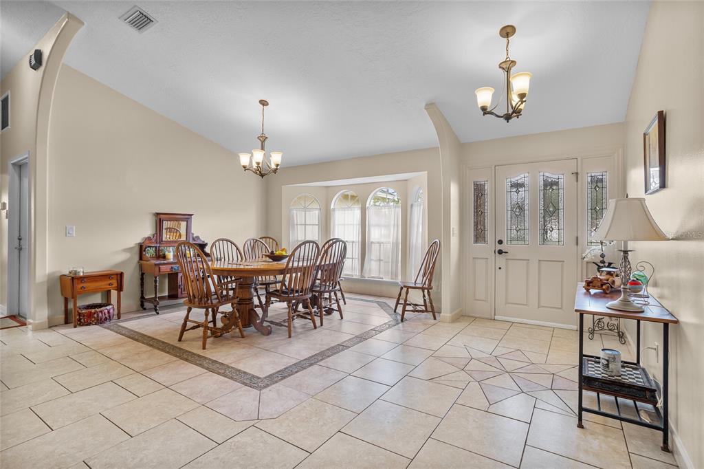 14612 Bray Road Orlando, FL 32832 - Photo 10 of 33 a view of a dining room with furniture and chandelier