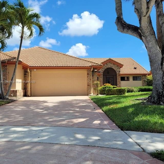 8380 Lords Place, Unit 8380 Boynton Beach, FL 33472 - Photo 1 of 21 a front view of a house with a garden and yard