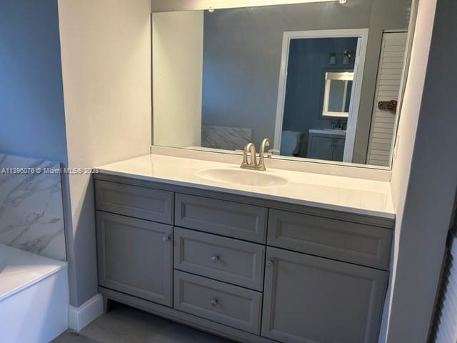 8380 Lords Place, Unit 8380 Boynton Beach, FL 33472 - Photo 12 of 21 a bathroom with a sink and a mirror