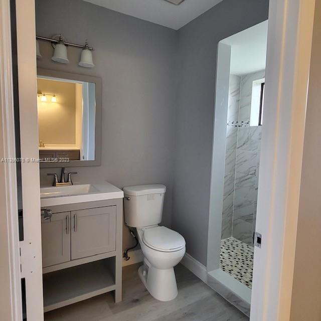 8380 Lords Place, Unit 8380 Boynton Beach, FL 33472 - Photo 14 of 21 a bathroom with a toilet a sink and mirror