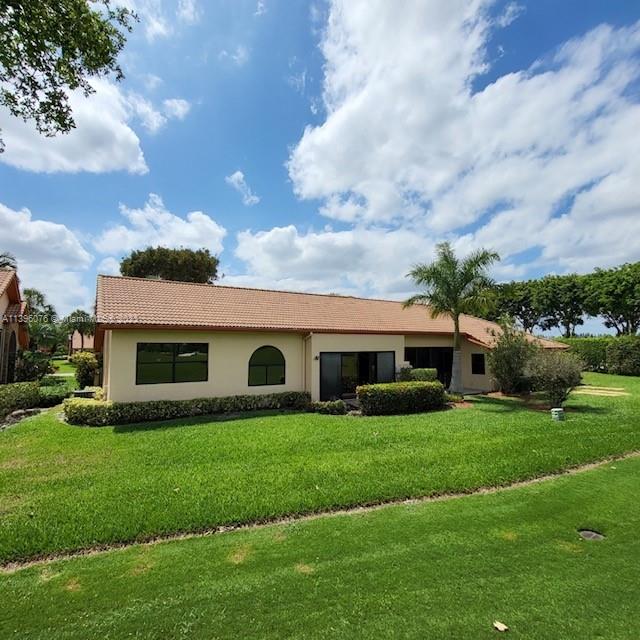8380 Lords Place, Unit 8380 Boynton Beach, FL 33472 - Photo 20 of 21 a view of house with yard