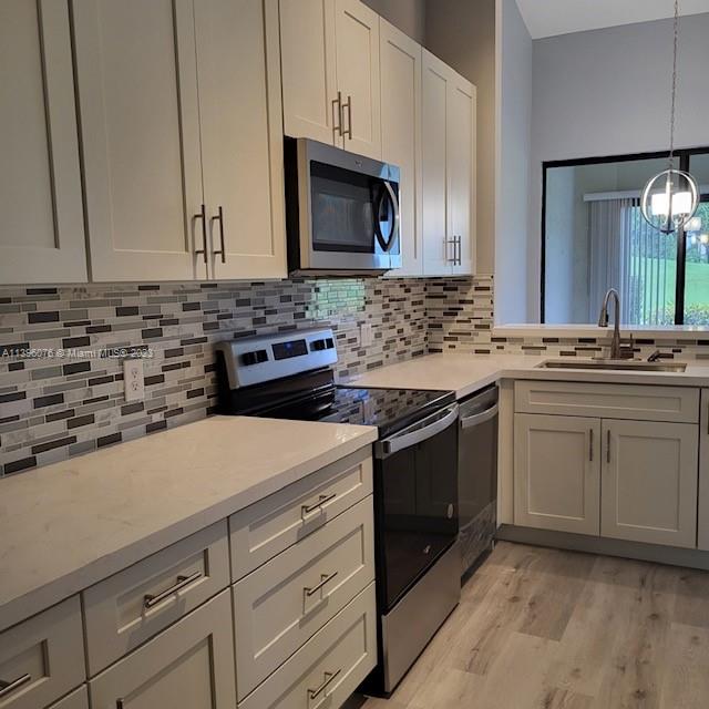 8380 Lords Place, Unit 8380 Boynton Beach, FL 33472 - Photo 3 of 21 a kitchen with a stove and a sink