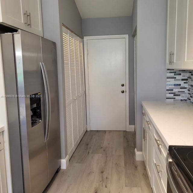8380 Lords Place, Unit 8380 Boynton Beach, FL 33472 - Photo 4 of 21 a view of a kitchen from the hallway