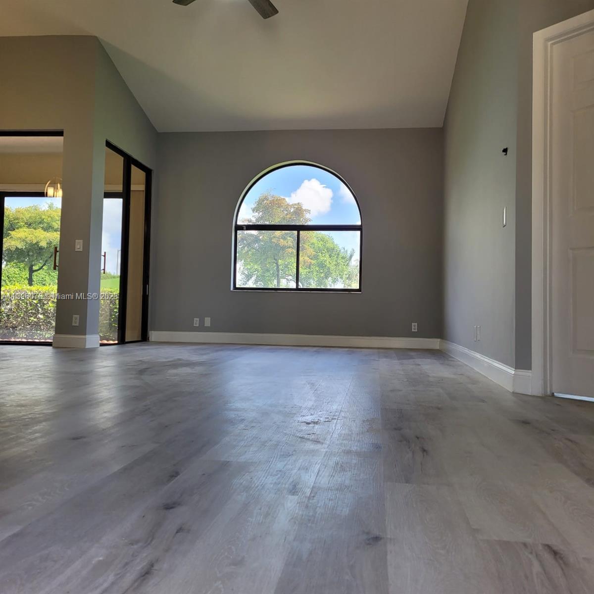 8380 Lords Place, Unit 8380 Boynton Beach, FL 33472 - Photo 7 of 21 an empty room with large windows and a fireplace