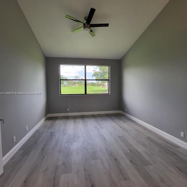 8380 Lords Place, Unit 8380 Boynton Beach, FL 33472 - Photo 9 of 21 an empty room with wooden floor and windows