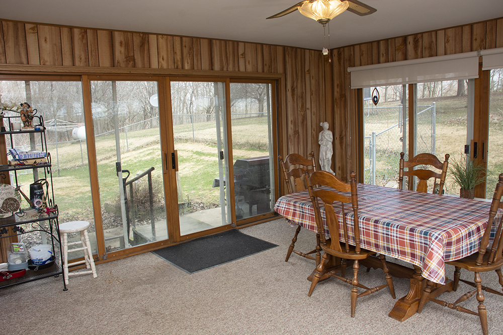 18474 Holly Road Morrison, IL 61270 - Photo 23 of 45 a bedroom with a bed and a chandelier