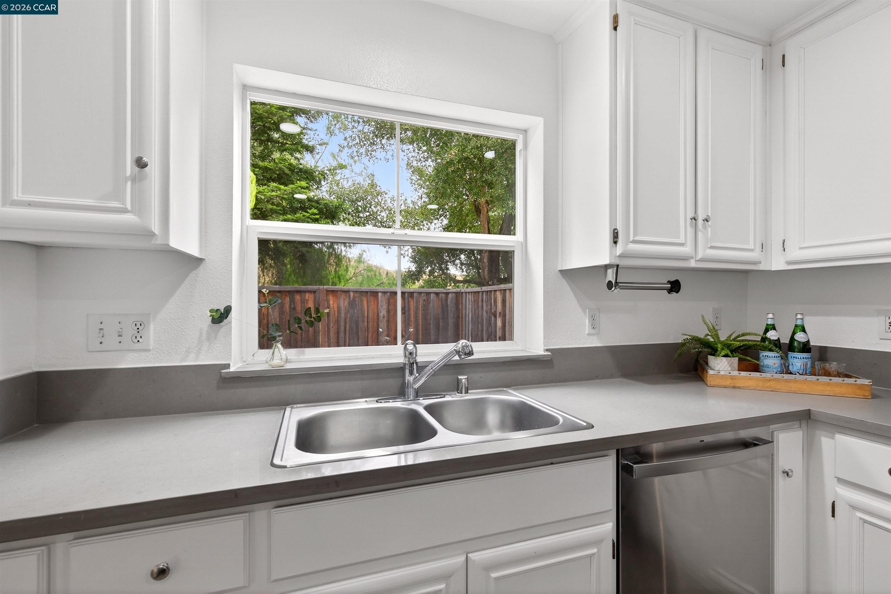 124 Coralflower Lane San Ramon, CA 94582 - Photo 13 of 47 a kitchen with stainless steel appliances white cabinets a sink and a window