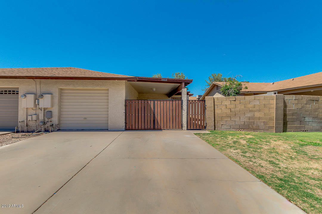 1860 East Inverness Avenue Mesa, AZ 85204 - Photo 1 of 29 a backyard of a house with a garage