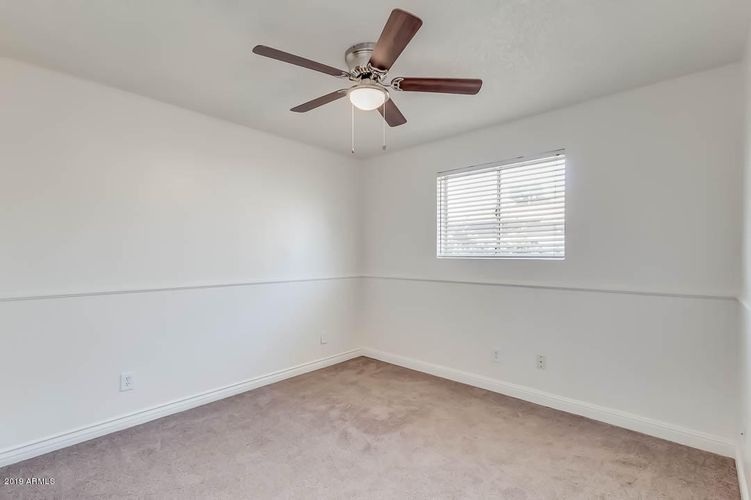 1860 East Inverness Avenue Mesa, AZ 85204 - Photo 20 of 29 an empty room with a window and a fan