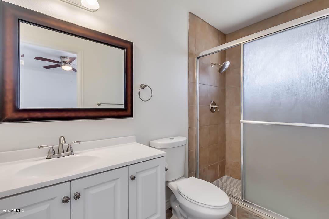 1860 East Inverness Avenue Mesa, AZ 85204 - Photo 23 of 29 a bathroom with a toilet a sink a vanity and mirror
